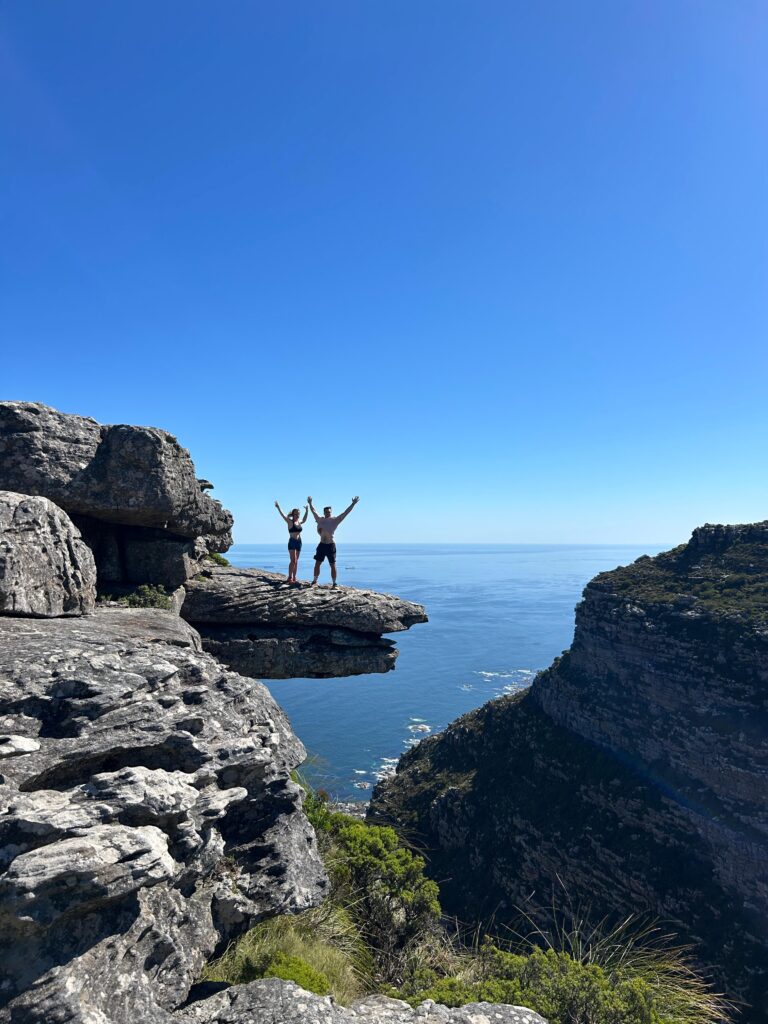 Hiker on the Diving Board ledge on the Kasteelspoort trail, Table Mountain