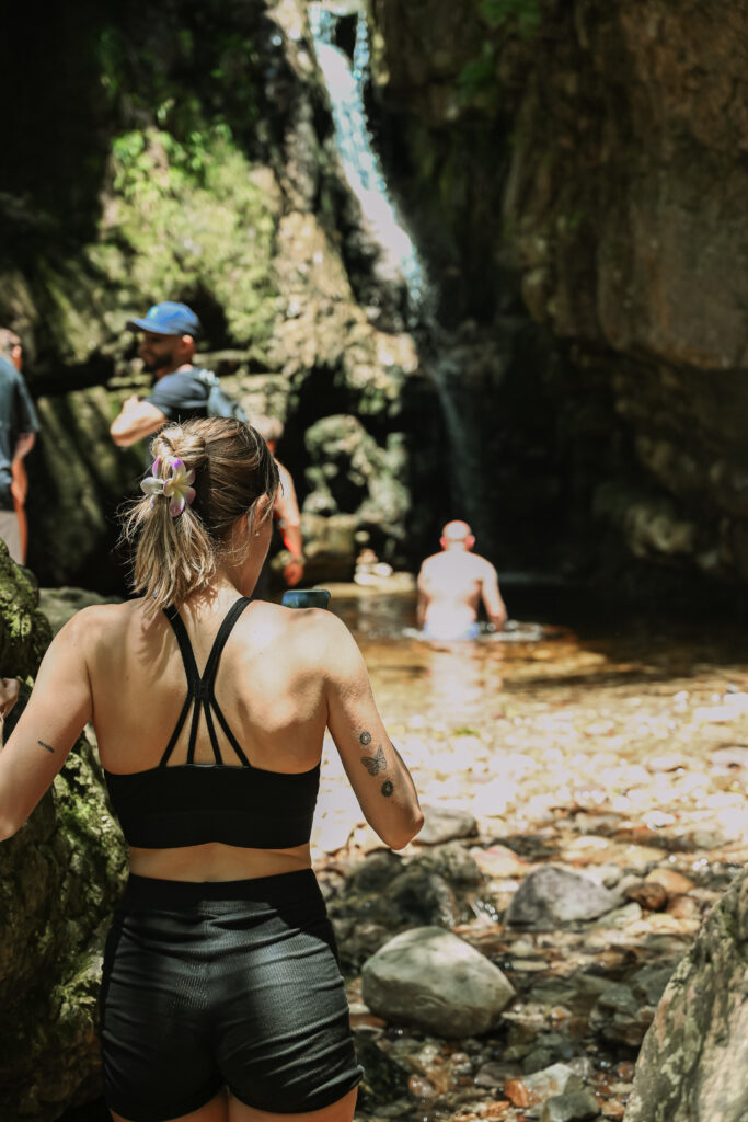 Hiker on a trail near Cape Town approaching a waterfall
